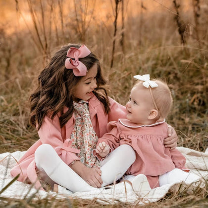 little girls wearing mauve pink and 4 inch hair bows