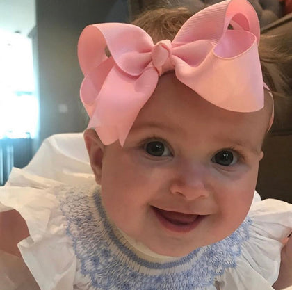 baby girl wearing big bow headband