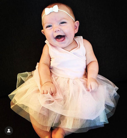 baby girl wearing headband with small bow
