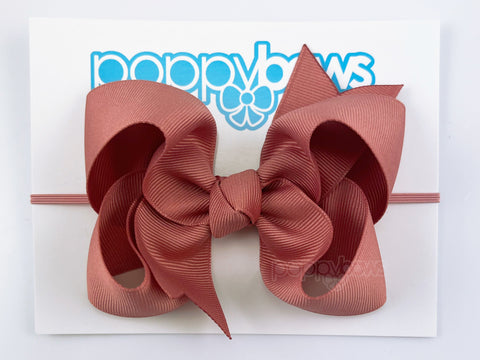 baby headband with large bow in burnt orange dusty rose