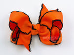 small halloween hair bow for baby girl in orange and black moonstitch ribbon