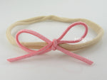 pink baby girls bow headband in suede on nylon