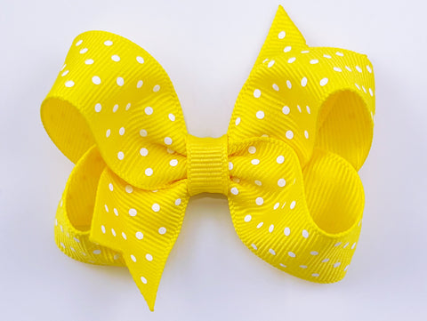 yellow and white polka dot hair bow