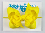 yellow baby bow headband on elastic