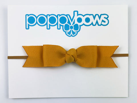 mustard yellow baby bow headband on elastic