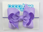 light purple baby bow headband on elastic