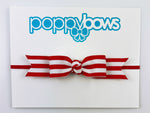 red and white striped baby girl headband with long bow on elastic