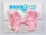 light pink pom pom baby headband with large bow