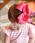 little girl with a pink hair bow