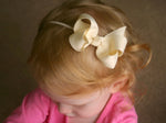 ivory baby girl's bow headband on elastic or nylon