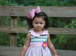 little girl wearing pink hair bow