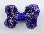 small baby hair bow in purple glitter