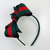 red and dark green headband with big bow on top