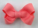 small bright coral hair bow