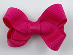 small bright pink hair bow